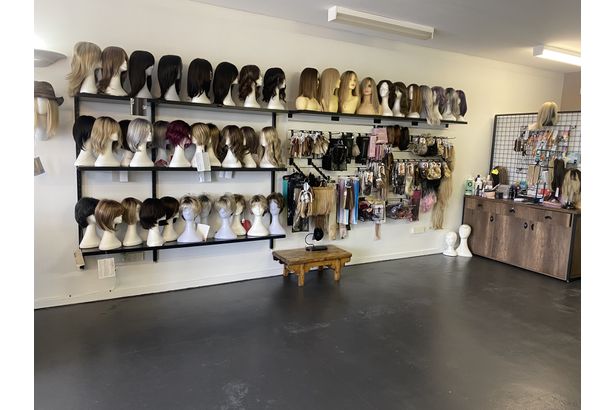 Premium display of wigs on a mannequin head.