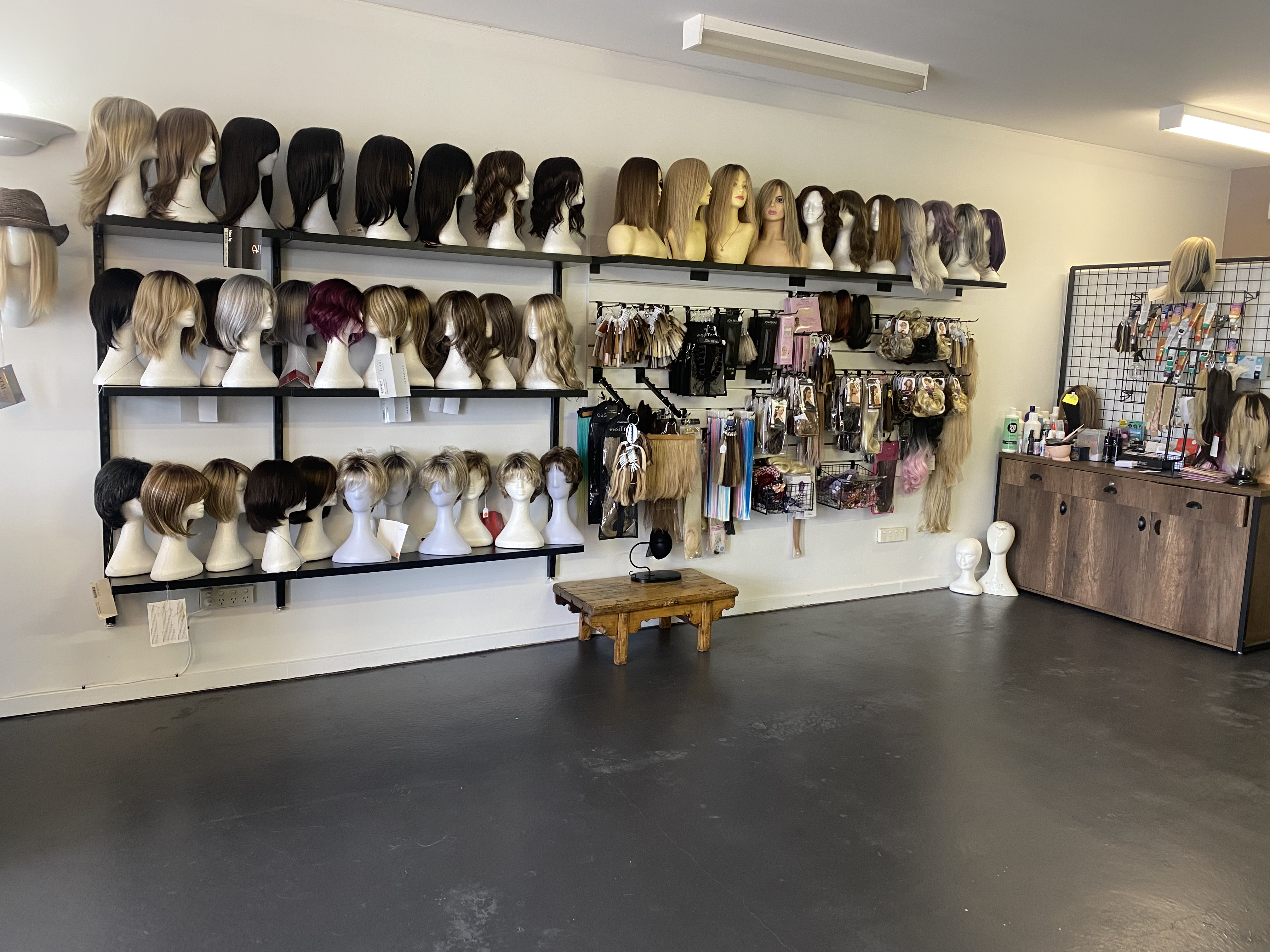 Premium display of wigs on a mannequin head.